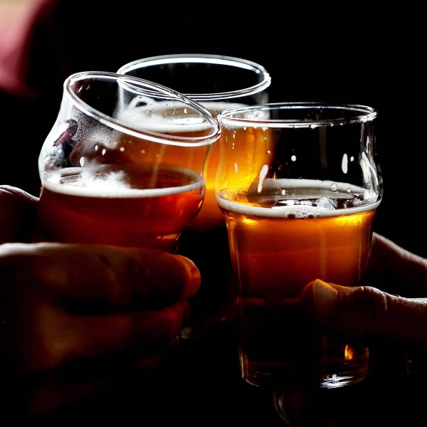 SANTA ROSA, CA - FEBRUARY 07:  Russian River Brewing Company customers clink their glasses while drinking the newly released Pliny the Younger triple IPA beer on February 7, 2014 in Santa Rosa, California.  Hundreds of people lined up hours before the opening of Russian River Brewing Co. to taste the 10th annual release of the wildly popular Pliny the Younger triple IPA beer that will only be available on tap from February 7th through February 20th. Craft beer aficionados rank Pliny the Younger as one of the top beers in the world. The craft beer sector of the beverage industry has grown from being a niche market into a fast growing 12 billion dollar business, as global breweries continue to purchase smaller regional craft breweries such this week's purchase of New York's Blue Point Brewing by AB Inbev.  (Photo by Justin Sullivan/Getty Images)